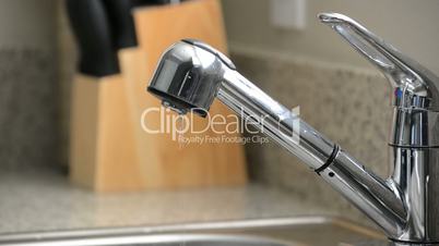 Close up of dripping kitchen sink faucet