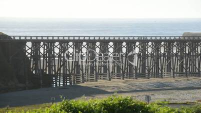Bicycle crosses a foot bridge by the ocean shore