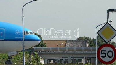 KLM airplane on taxiway with a speed sign 11036