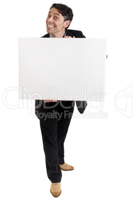 Businessman with a cheesy grin holding a sign