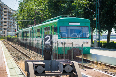 green suburb train waiting on a staition in budapest