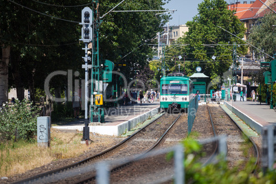green suburb train waiting on a staition in budapest