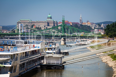 cruise ships docked on danube river shore in budapest