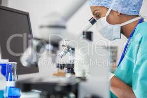Asian Woman Doctor Scientist Using Microscope In Laboratory