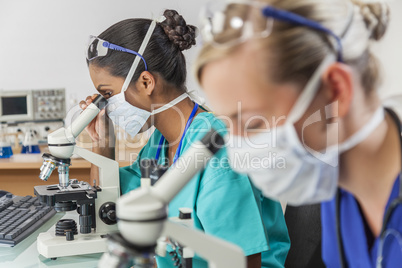 Asian Female Scientist Using Microscope in Laboratory