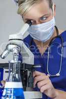 Female Scientist Doctor in Laboratory Using Microscope