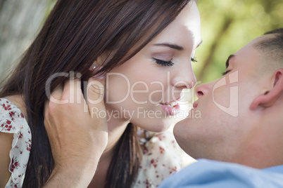 Mixed Race Romantic Couple Kissing in the Park