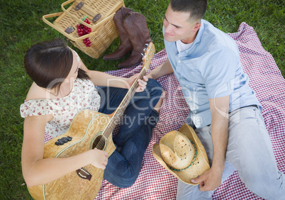 Mixed Race Couple at the Park Playing Guitar and Singing