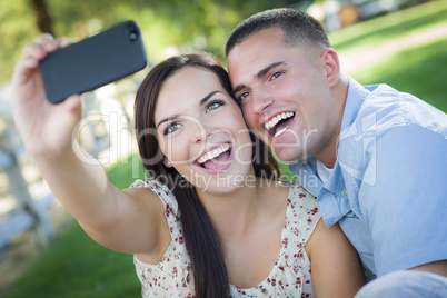 Mixed Race Couple Taking Self Portrait in Park