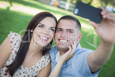 Mixed Race Couple Taking Self Portrait in Park