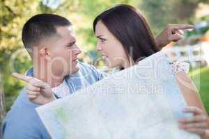 Confused Mixed Race Couple Looking Over Map Outside