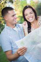 Mixed Race Couple Looking Over Map Outside Together