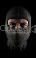 Masked man on a dark background