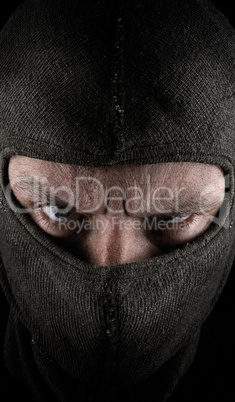 Masked man on a dark background