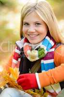 Smiling young girl autumn colorful scarf leaves