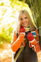 Happy blonde teenager girl autumn forest smiling