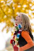 Carefree laughing young blonde girl autumn forest