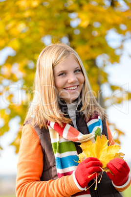 Smiling blonde teen girl autumn forest leaves