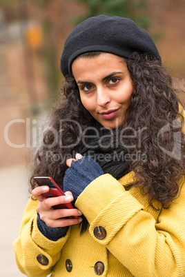 Woman with cell phone in fall nature