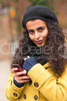 Woman with cell phone in fall nature