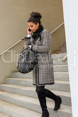 Woman leaving office making phone call