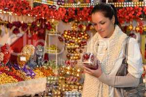 Woman at Christmas decoration shop with balls
