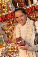 Happy woman buying Christmas balls at shop