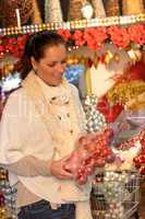 Happy woman buying Christmas decoration