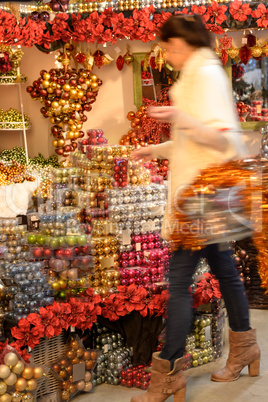 Blurry woman buyer shopping Christmas decorations