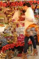 Blurry woman buyer shopping Christmas decorations