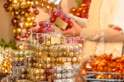 Buyer shopping Christmas balls in plastic boxes
