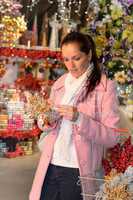 Woman buying Christmas ornaments in shop