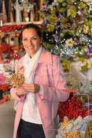 Smiling woman shopping Xmas decorations in shop