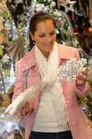 Smiling woman customer buying snowflake ornament