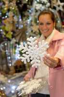 Woman purchasing Christmas snowflake ornament shop