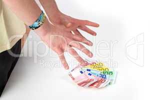 Hands reach for banknotes on the table
