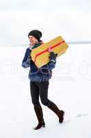 Woman running with package in the winter landscape