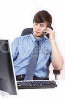 Young businessman calling by phone in the office
