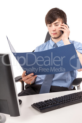 Young businessman examining contract with the phone in the office