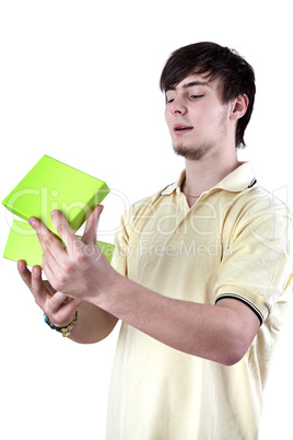 Young man looking in gift box