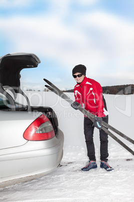 Woman with car during unloading of cross-country skis