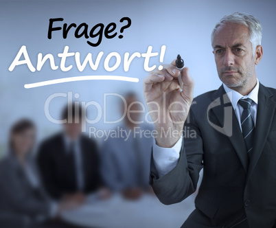 Attractive businessman holding a marker and writing frage antwor