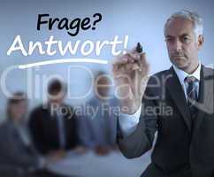 Attractive businessman holding a marker and writing frage antwor