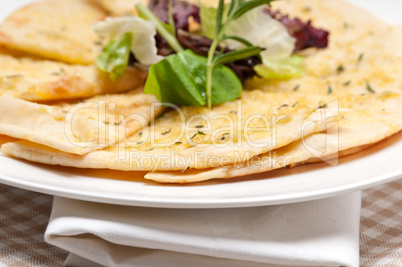 garlic pita bread pizza with salad on top