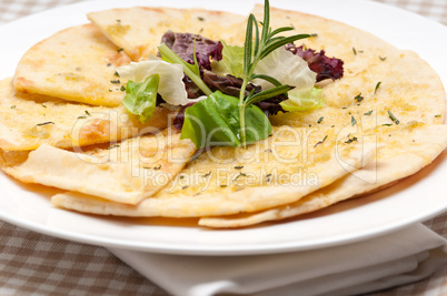 garlic pita bread pizza with salad on top