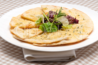 garlic pita bread pizza with salad on top