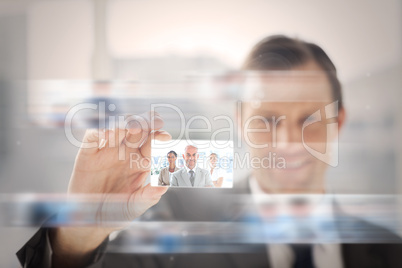 Pleased businessman presenting a picture of a business team