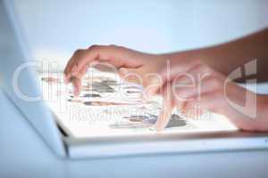 Close up of hands selecting pictures on a futuristic laptop