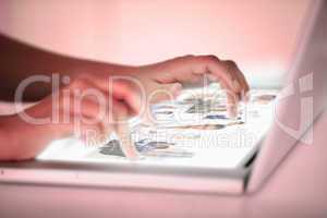 Close up of hands picking pictures on a futuristic laptop