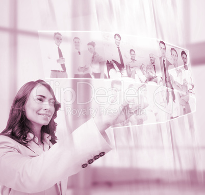 Pleased businesswoman scrolling pictures on digital screen